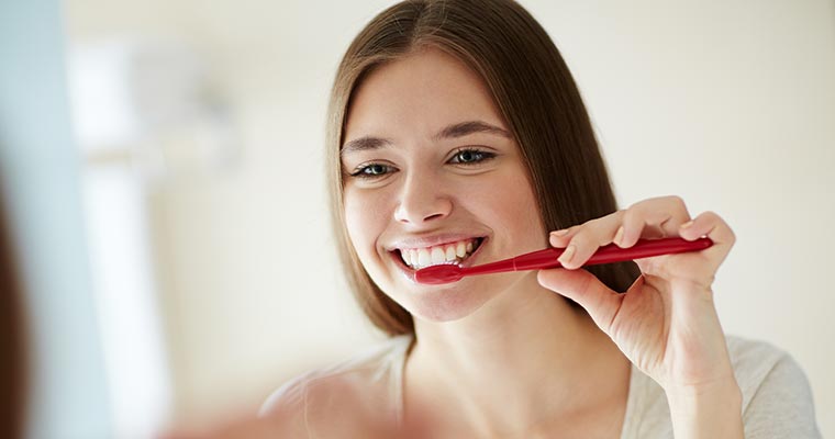 Young girl practicing oral hygiene during COVID-19