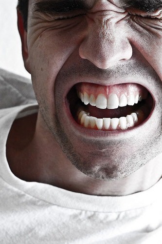 Man grimacing in dental pain