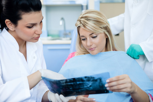 Female patient revewing her dental x-ray with a dentist