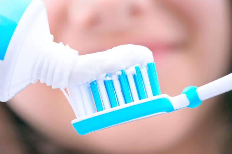Close up of toothpaste being squeezed onto a toothbrush